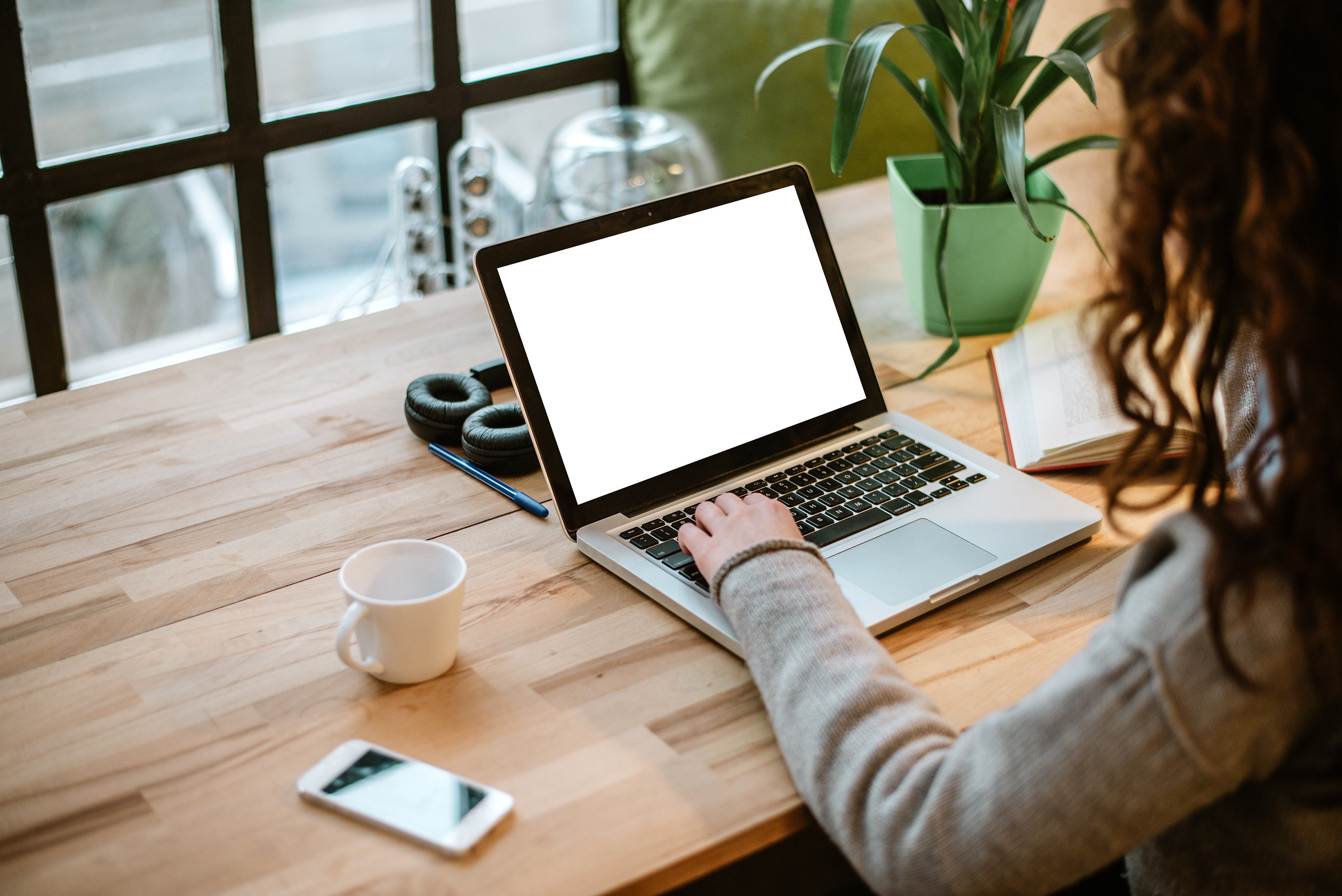 Woman Working On Laptop With White Screen In Modern Office Sureteam